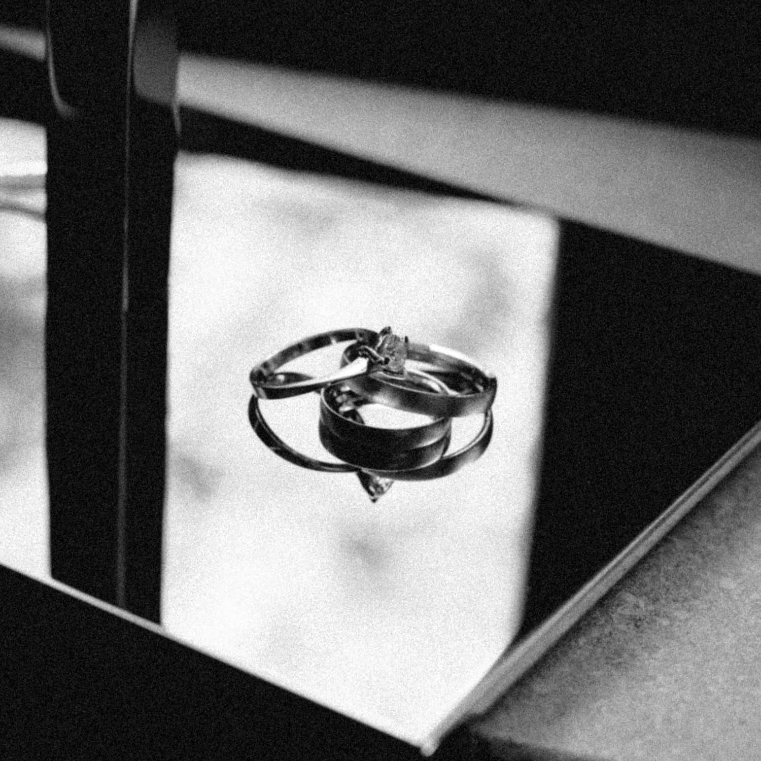 Wedding rings on a mirror, in black and white